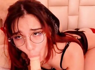 Redhead with glasses gives a blowjob to her dildo so you can imagine that she sucks you