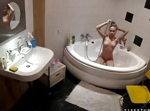 Slim brown-hiared chick fondles her nice body in the bathroom