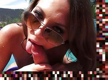 Curious brunette Lily Love with glasses is giving amazing blowjob in the poolside