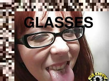 A redhead girl in glasses blows a big black cock in a toilet