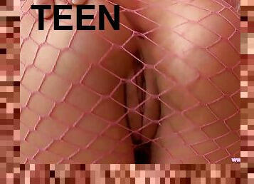 Sexy teen in pink fishnets toys her pussy with pink dildo