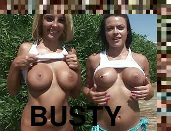 Busty lesbian with big tits displaying her nice ass seductively outdoor