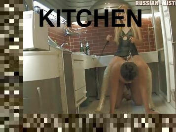 Upbeat foot fetish blonde in high heels riding on her slave in the kitchen