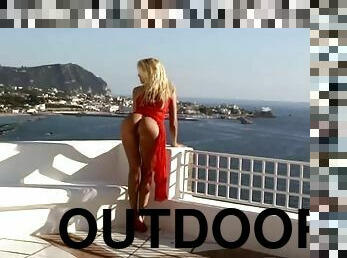 Gorgeous blond beauty in red dress shows her ass