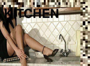 A foot fetish babe climbs up on the kitchen counter and shows her feet