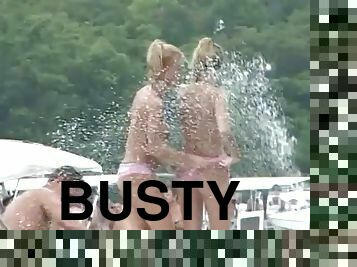 Two busty amateur blondes flash their boobs at an outdoor party