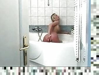 Hot blonde working her pussy in the shower