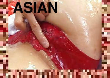 Oiled-up Asian whore with a gorgeous ass getting her pussy fingered