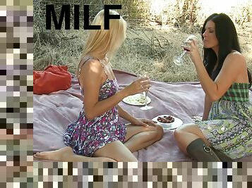 Milfs in pretty dresses have beautiful lesbian sex on a picnic