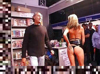 Captivating cougar in sexy thong drilling her shaved pussy with monster dildo in public