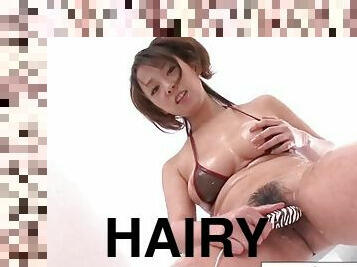 Teen in bikini oils up her hairy pussy