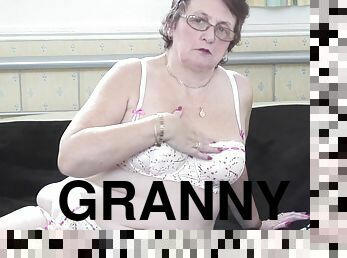 Curvy granny in stockings displaying her big natural tits in BBW shoot