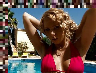 Curly blonde masturbates on a lounge by the poolside