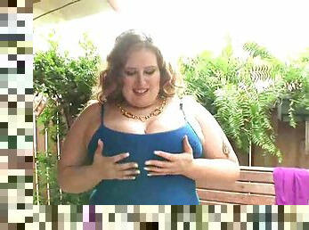 Chunky chick modeling outdoors and showing tits