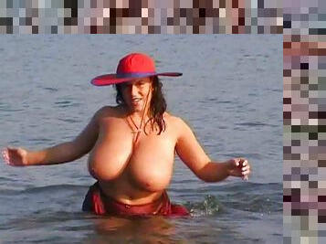 Chubby cougar with huge natural tits touching her hot body on the beach