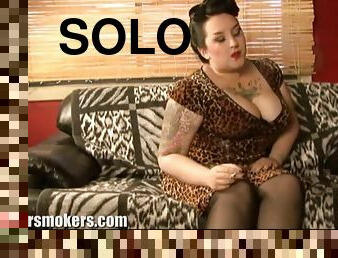 BBW with tattooed tits has a smoke on the sofa solo