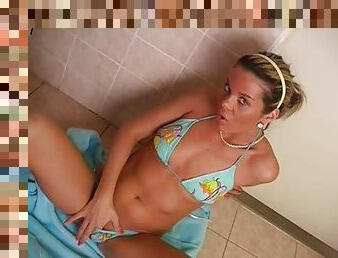 On the floor of the bathroom she works her pussy with a toy