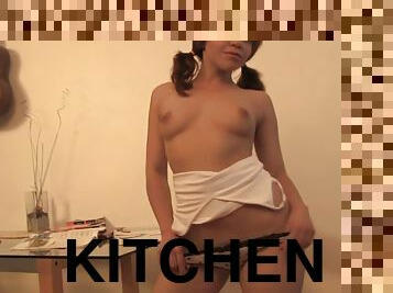 Redhead solo teen working on her twat as she rubs it nicely in the kitchen