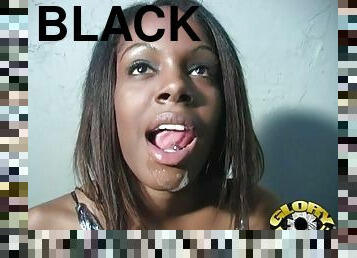 Dena Caly sucks on a big black cock through a gloryhole