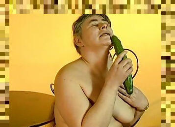 Lewd granny Julie moans loudly while fucking her vag with a cucumber