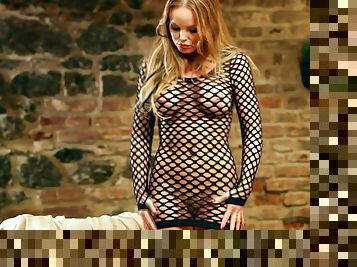 Silvia Saint poses in fishnet bodysuit and masturbates