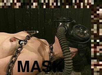 Horny siren gets a gas mask on her face, being tied up