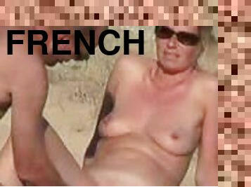 French hottie gets her pussy touched by her hubby on a nude beach