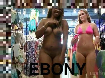 Blonde and ebony sluts flashing big butts in a store