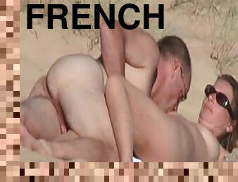 Naughty French woman gets fingered on the beach