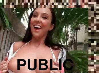 Brunette tempting girl shows her big tits in public