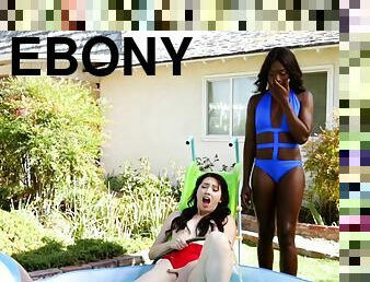 Ebony lesbian in bikini having her pussy licked in the pool
