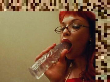 Redhead with glasses plows her pussy with a big dildo