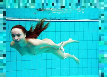 Russian redhead teen with small tits dives deep in the pool