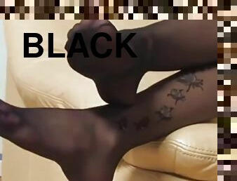 Sexy brunette black pantyhose foot tease