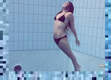 Seductive Russian filly Lucy Gurchenko swims in the pool while naked