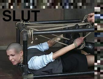 Bald slut simply enjoys being restrained in the dungeon