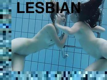 Two lovely babes enjoy making out passionately under the water