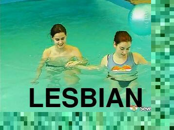 Salacious lesbians fondling in the pool before sharing a double ended dildo