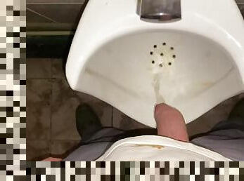 Hands-free pissing in a public toilet from an uncut dick