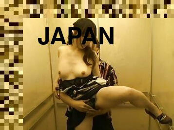 Japanese milf gets fucked from behind in an elevator cage