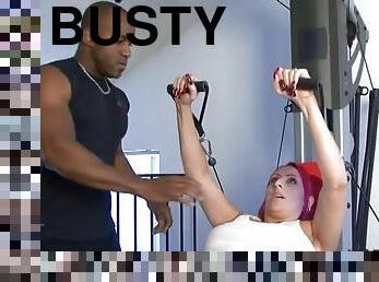 Busty redhead mom Raven Black fucks a black stud in a gym