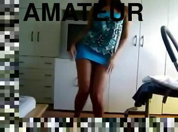 Brunette chick wearing a miniskirt dances in front of a webcam