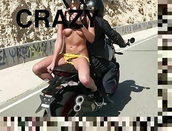 Crazy chick masturbating on back on motorcycle