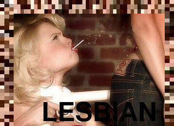 Cute blonde lesbians rub each other's cunts with a lollipop