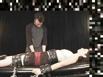 fully clothed man performing hardcore fetish action with an attractive lady