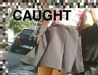 Chick wearing a miniskirt gets caught on a cam in the street