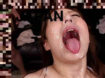 Attractive Japanese cowgirl gets a facial cumshot at a wild bukkake shoot