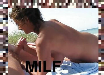 MILF gives head on the beach