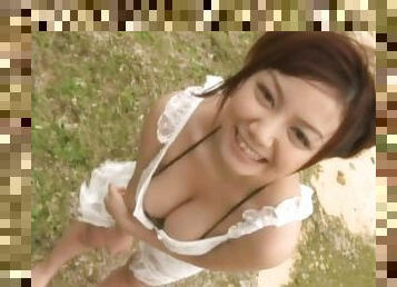 Busty Meguru Kosaka gives a blowjob outdoors