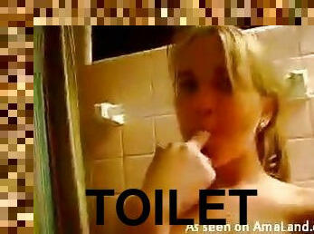 Blonde sitting on toilet masturbates